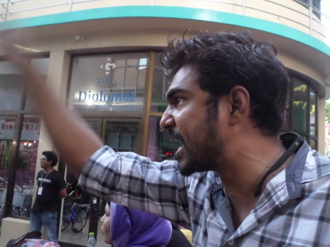 Where is my vote? An angry protester confronts security forces at a protest in Male' yesterday demanding early elections
