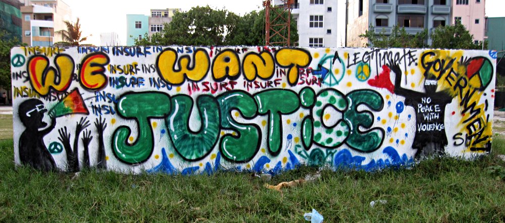 The term “insurf,” repeated in the background of this colorful message, is a deliberate mis-spelling of the Dhivehi word “insaafu” which means “'justice.” “Insurf” alludes to the popular surfing spot adjacent to the MDP rally area. Photo: maldivesculture.com