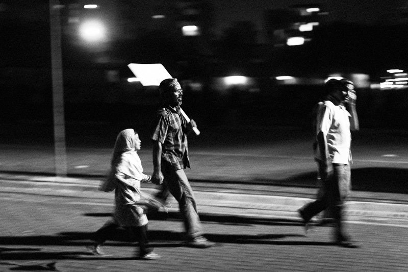 A man leads his young daughter to anti-government protests in the name of Islam, 23 December 2011. Photo: Aznym